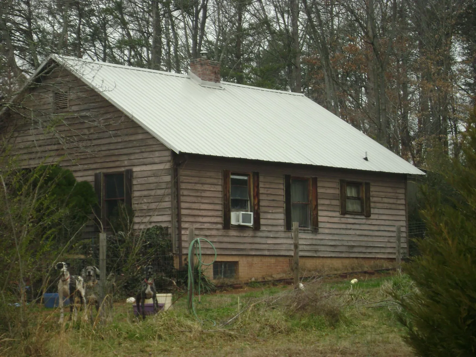 White metal roof on an old wood sided farmhouse, from a Metal Roof Installation job in Prole